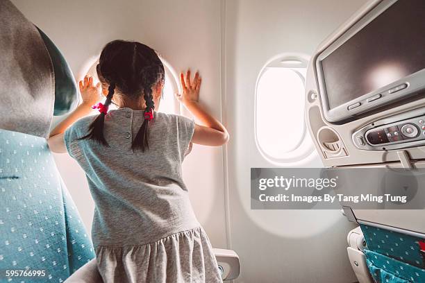 little girl anticipating aeroplane to take off - airplane seats stock pictures, royalty-free photos & images