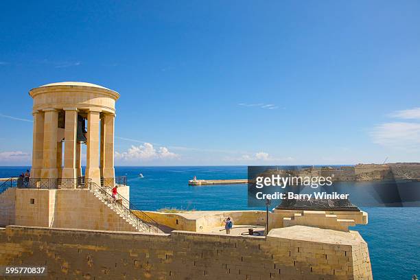 memorial, forts and limestone walls of valletta - conflict minerals stock pictures, royalty-free photos & images