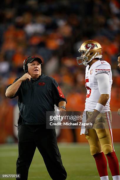 Head Coach Chip Kelly of the San Francisco 49ers talks with Christian Ponder during the game against the Denver Broncos at Sports Authority Field on...