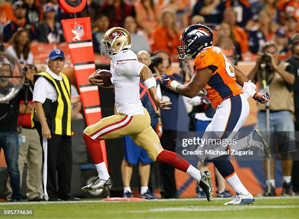 Christian Ponder of the San Francisco 49ers rushes for a 22-yard touchdown during the game against the Denver Broncos at Sports Authority Field on...