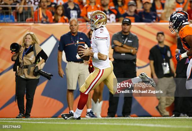 Christian Ponder of the San Francisco 49ers rushes for a 22-yard touchdown during the game against the Denver Broncos at Sports Authority Field on...