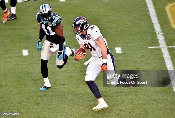 Owen Daniels of the Denver Broncos runs with the ball pursued by Roman Harper of the Carolina Panthers during Super Bowl 50 at Levi's Stadium on...