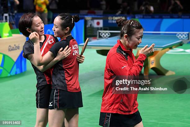 Kasumi Ishikawa, Mima Ito and Ai Fukuhara of Japan celebrate winning the bronze medals after beating Singapore in the Table Tennis Women's Team...