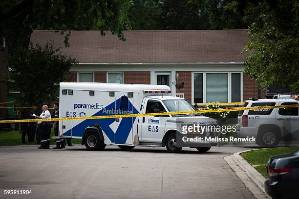 Police investigate the scene of the crime where three people were shot by a crossbow on Lawndale Road in Scarborough.