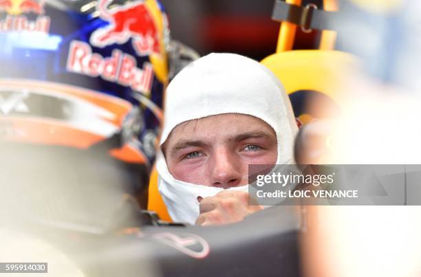 Red Bull Racing's Belgian-Dutch driver Max Verstappen sits in his car in the pits during the second practice session at the Spa-Francorchamps circuit...