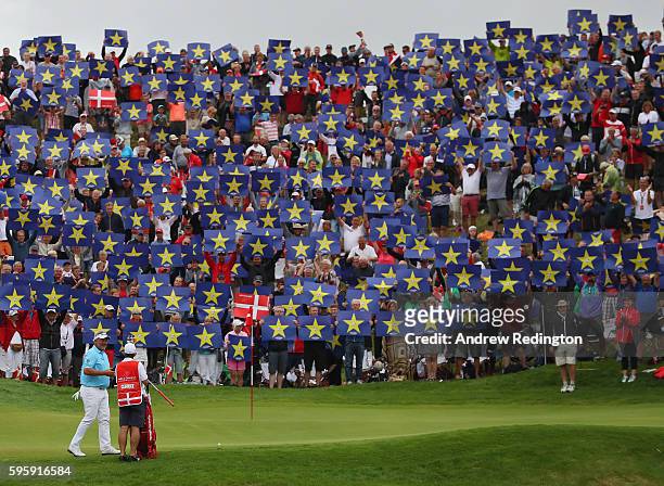 Crowds hold up Go Europe placards for the European Ryder Cup Team Captain Darren Clarke on the 16th green during the second round of Made in Denmark...
