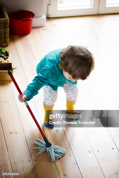 Berlin, Germany A toddler is playing with a mop on August 11, 2016 in Berlin, Germany.