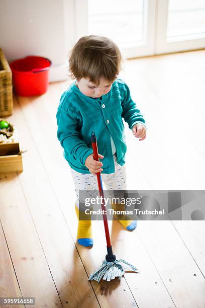 Berlin, Germany A toddler is playing with a mop on August 11, 2016 in Berlin, Germany.