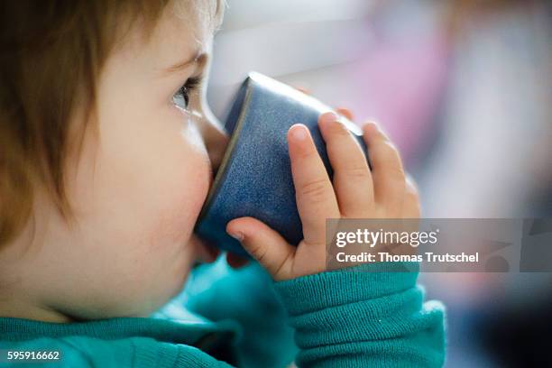 Berlin, Germany A toddler is drinking from a cup on August 11, 2016 in Berlin, Germany.