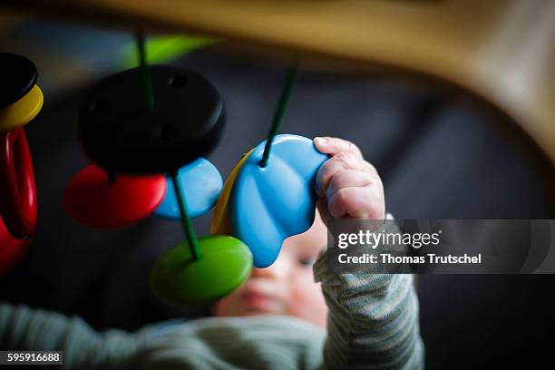 Berlin, Germany A baby is playing with a gripping toy on August 11, 2016 in Berlin, Germany.