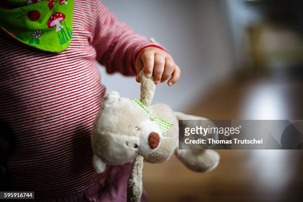 Berlin, Germany A toddler holds a stuffed animal in his hand on August 12, 2016 in Berlin, Germany.