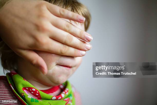 Berlin, Germany A mother holds her hand in front of her infant's eyes on August 12, 2016 in Berlin, Germany.