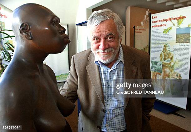 French anthropologist Yves Coppens poses next to a model of Lucy, a female australopithecus, on July 10, 2004 in Carnac as part of an exhibition...