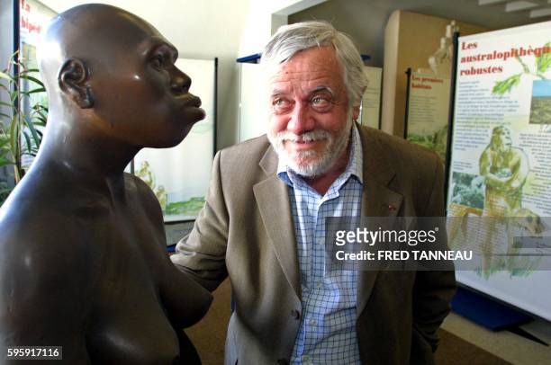 French anthropologist Yves Coppens poses next to a model of Lucy, a female australopithecus, on July 10, 2004 in Carnac as part of an exhibition...