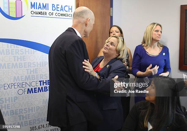 Florida Governor Rick Scott speaks with Rep. Ileana Ros-Lehtinen as they attend a round table discussion about Zika preparedness in the Miami Beach...