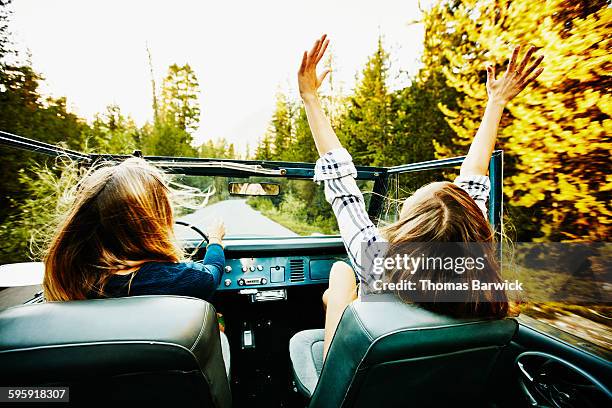 woman riding with friend in convertible - exhilaration fotografías e imágenes de stock