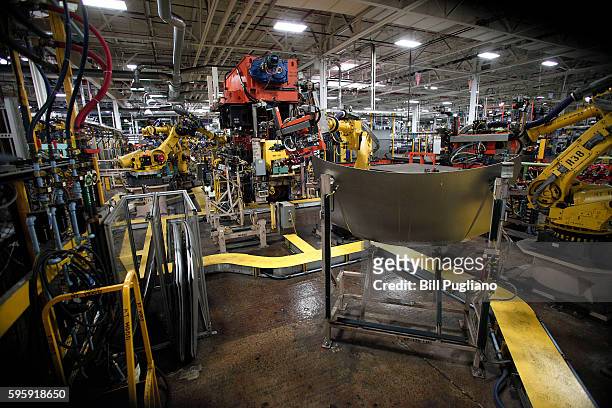 Robots work with parts for Fiat Chrysler Automobiles at the FCA Sterling Stamping Plant August 26, 2016 in Sterling Heights, Michigan. An event was...