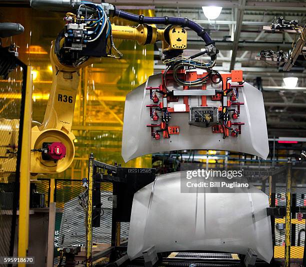 Robot handles a hood for a Fiat Chrysler Automobiles vehicle at the FCA Sterling Stamping Plant August 26, 2016 in Sterling Heights, Michigan. An...