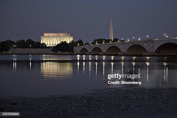 The Lincoln Memorial, left, and Washington Monument, stand past the Arlington Memorial Bridge in Washington, D.C., U.S., on Thursday, Aug. 25, 2016....