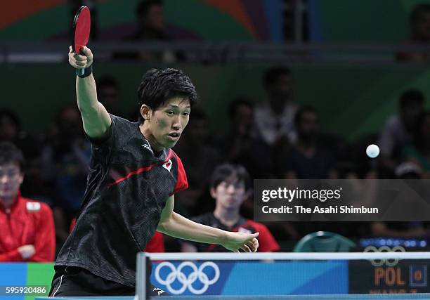 Maharu Yoshimura of Japan competes against Wang Zengyi of Poland in the Table Tennis Men's Team Round One Match between Japan and Poland during Day 8...