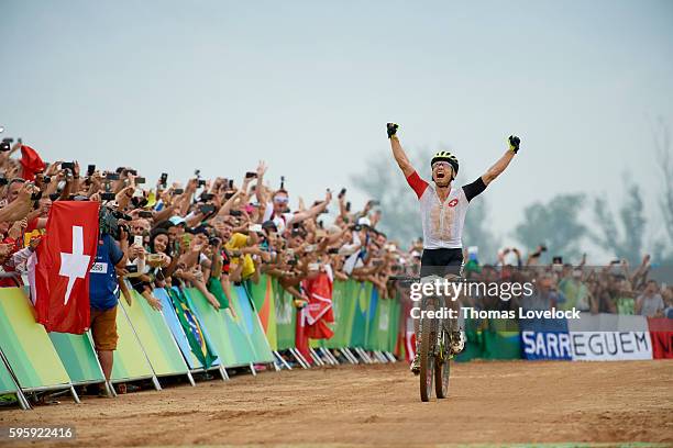 Summer Olympics: Switzerland Nino Schurter in action, victorious at the finish of the Men's Cross-Country Final at the Mountain Bike Centre. Schurter...