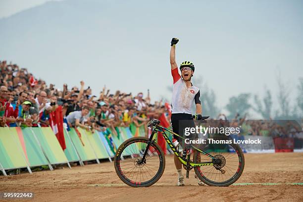 Summer Olympics: Switzerland Nino Schurter victorious at the finish of the Men's Cross-Country Final at the Mountain Bike Centre. Schurter wins Gold....