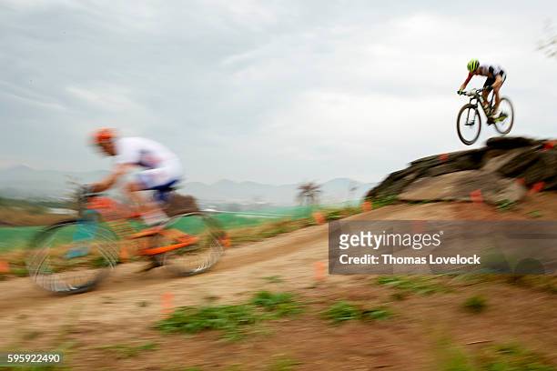 Summer Olympics: Blur view of Switzerland Nino Schurter in action during Men's Cross-Country Final at the Mountain Bike Centre. Rio de Janeiro,...