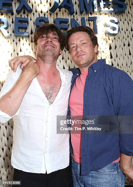 Alex James and Jamie Oliver playing songs at the Cheese Hub on the first day of The Big Feastival at Alex James' Farm on August 26, 2016 in Kingham,...