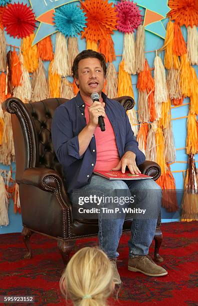Jamie Oliver reads a story to children in the Big Top at The Big Feastival at Alex James' Farm on August 26, 2016 in Kingham, Oxfordshire.