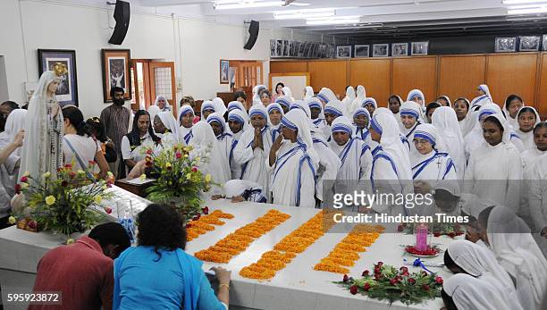 Nuns offering morning prayers on the occasion of Mother Teresa's 106th birth anniversary, near Mother's Tomb at Mother House on August 26, 2016 in...