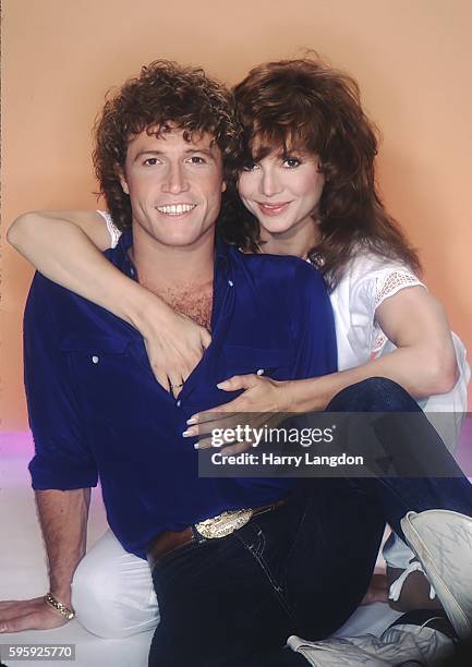 Singer Andy Gibb and girlfriend actress Victoria Principal pose for a portrait in 1981 in Los Angeles, California.