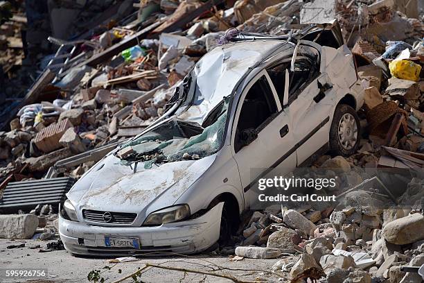 Car lies crushed by rubble after a building collapse during Wednesday's earthquake, on August 26, 2016 near Amatrice, Italy. Italy has declared a...