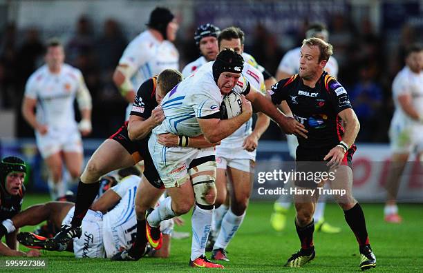 Thomas Waldrom of Exeter Chiefs is tackled by Sarel Pretorius of Newport Gwent Dragons during the Pre Season Friendly match between Newport Gwent...