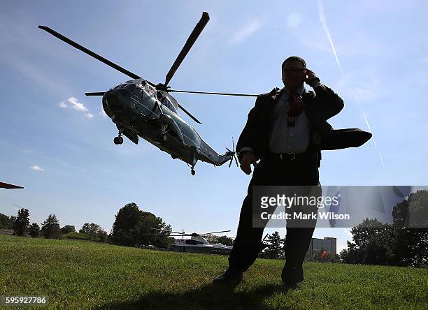 Member of the US Secret Service stands guard as Marine One carrying US President Barack Obama lands at Walter Reed National Medical Center August 26,...