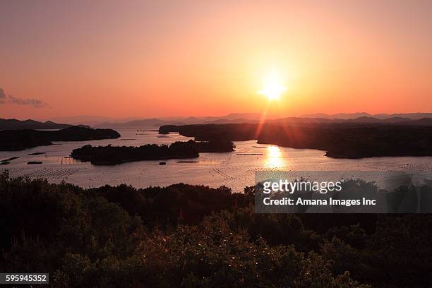 sun setting over ago bay - mie prefecture stock pictures, royalty-free photos & images