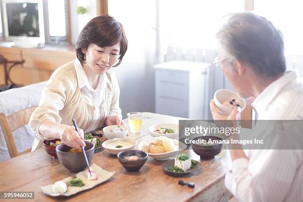 mature couple having japanese breakfast - man eating woman out ストックフォトと画像