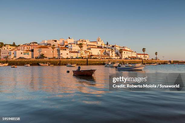 sunset on the fishing village ferragudo portugal - portimão stock pictures, royalty-free photos & images