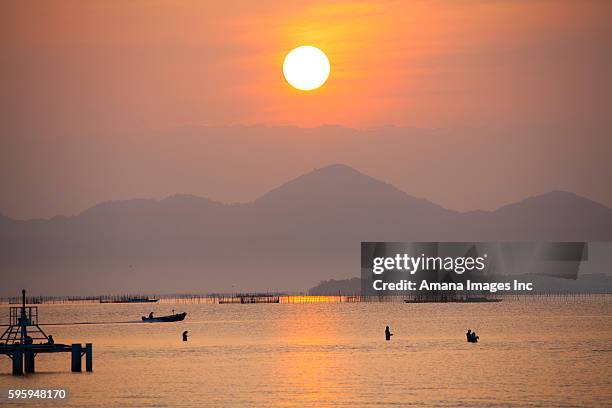 sunrise seen from foot of biwako ohashi - omi stock pictures, royalty-free photos & images