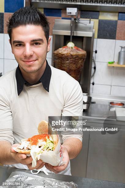 young chef holding a d??ner kebab - doner kebab stock pictures, royalty-free photos & images