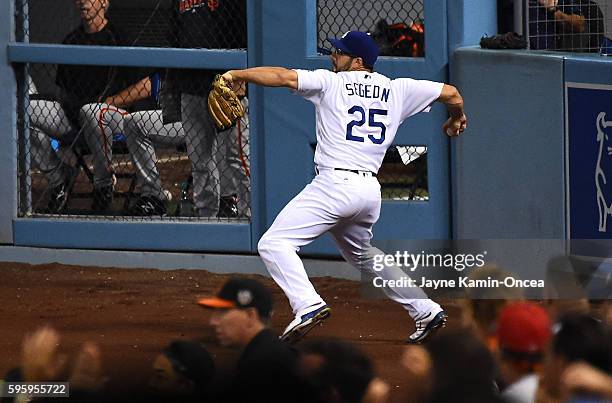 Rob Segedin of the Los Angeles Dodgers makes a throw from right field during the game against the San Francisco Giants at Dodger Stadium on August...