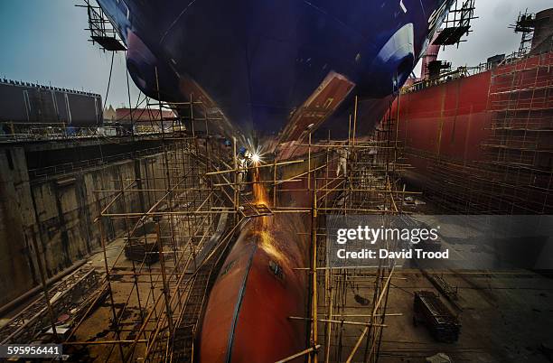 welders working at a ship building yard in china. - shipyard stock-fotos und bilder