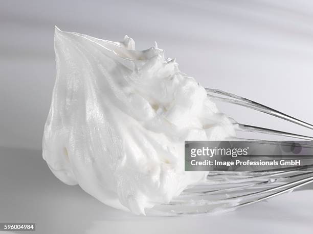 beaten egg white on whisk - bianco d'uovo foto e immagini stock