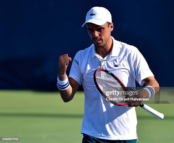 Roberto Bautista Agut of Spain reacts after the final point of his win over Viktor Troicki of Russia in the semifinals of the Winston-Salem Open at...