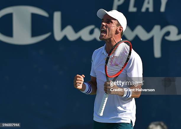 Roberto Bautista Agut of Spain reacts after the final point of his win over Viktor Troicki of Russia in the semifinals of the Winston-Salem Open at...
