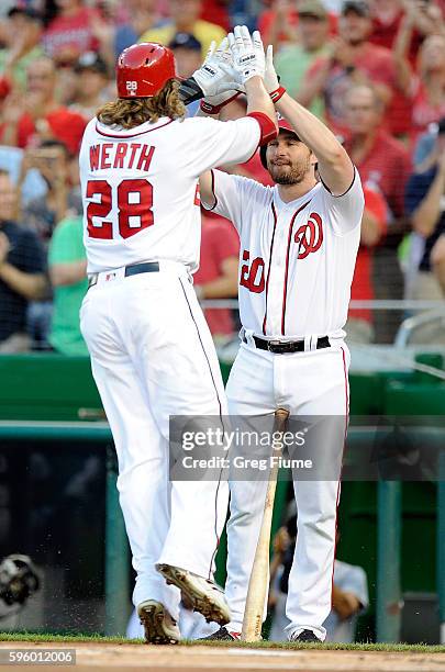 Jayson Werth of the Washington Nationals celebrates with Daniel Murphy after hitting a home run in the first inning against the Colorado Rockies at...
