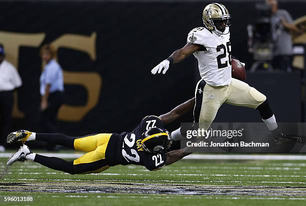 Spiller of the New Orleans Saints is tackled by William Gay of the Pittsburgh Steelers during the first half of a game at the Mercedes-Benz Superdome...