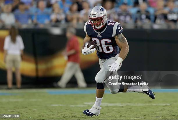 Tyler Gaffney of the New England Patriots runs the ball against the Carolina Panthers in the 2nd quarter during their game at Bank of America Stadium...