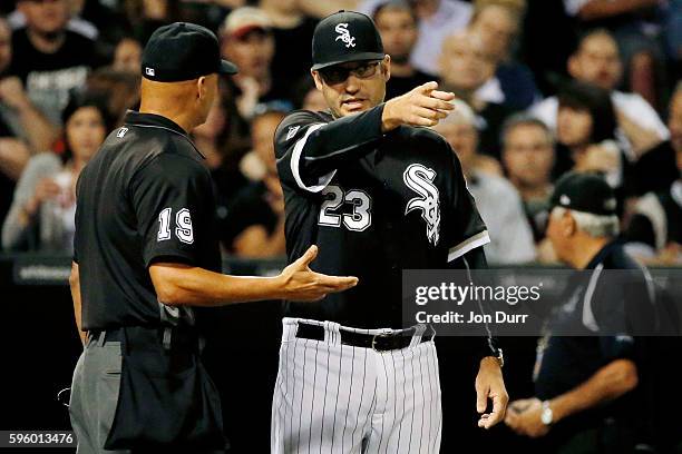 Manager Robin Ventura of the Chicago White Sox talks with home plate umpire Vic Carapazza after J.B. Shuck was tagged out by Mike Zunino of the...