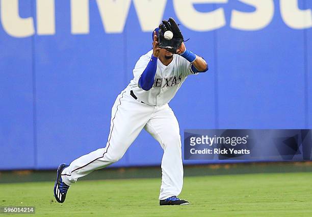Carlos Gomez of the Texas Rangers catches a long fly ball to left field in the second inning against the Cleveland Indians at Globe Life Park in...