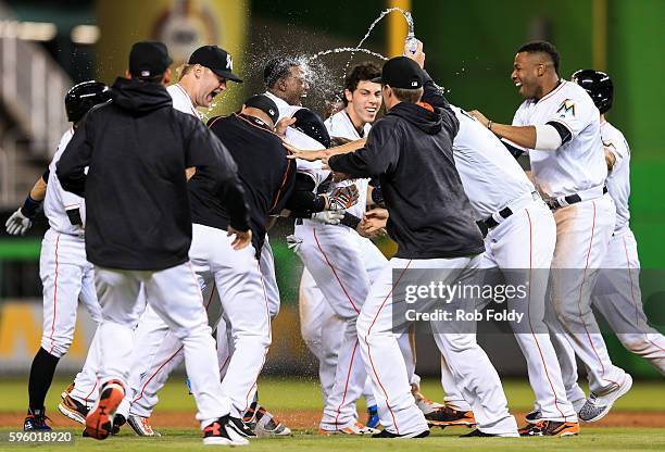 Chris Johnson of the Miami Marlins celebrates with teammates after hitting a walk-off double to end the game against the San Diego Padres at Marlins...